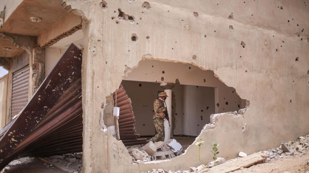 Un soldat du Front national de libération de l'Azawad (FLA) dans un bâtiment endommagé à Kidal, illustrant la prise de la ville par les groupes armés